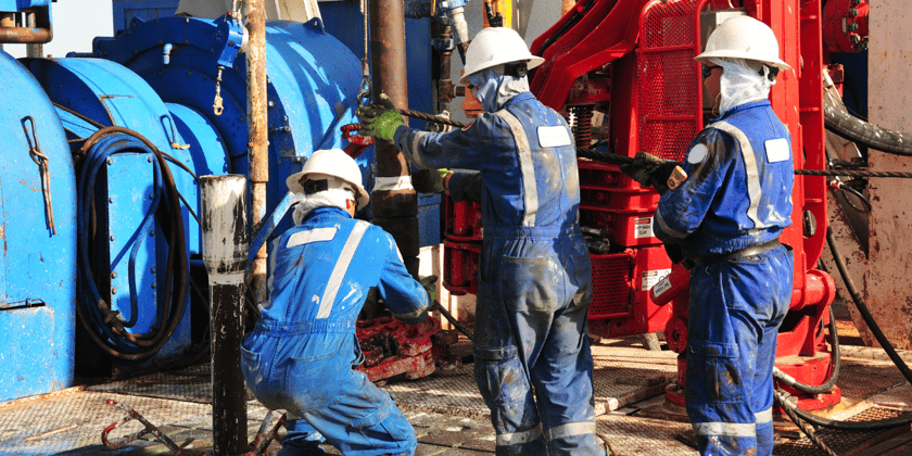 A group of drilling rig operators working on an oil rig. (2)